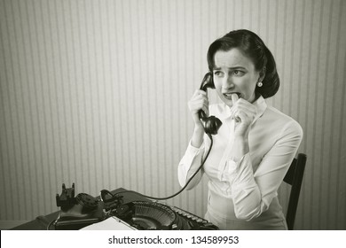 Woman Embarrassed Talking On Phone At Her Desk