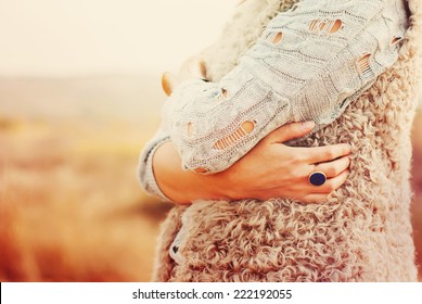 The Woman Embraces Herself Hands, Ring in the finger, outdoor