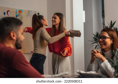 woman embracing friend during family gathering at dinner party - Powered by Shutterstock