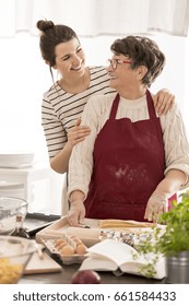 Woman Embracing Her Grandma While Cooking Together