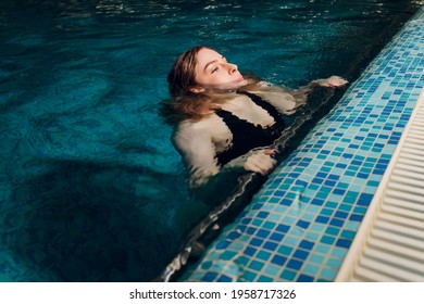 Woman Emerging From Swimming Underwater At The Pool.