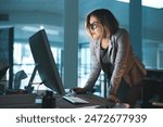 Woman, employee and reading on computer in office on browsing internet, online and research for ideas. Female person, workplace and desk with deadline or overtime, project and standing as hr