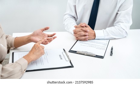 Woman employer is asking with candidate question and explaining about job description to applicant while sitting to job interview in office - Shutterstock ID 2137592985
