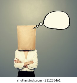 woman and empty paper bag the head   drawing speech balloon over dark background