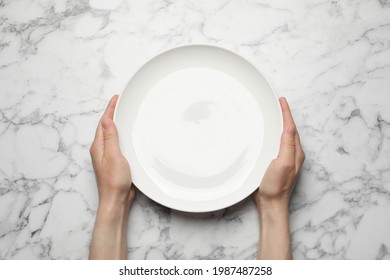 Woman With Empty Plate At White Marble Table, Top View