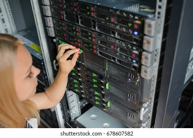 Woman It Engeneer Work In Modern Interior Of Server Room In Datacenter.