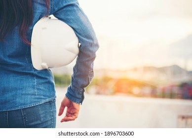 Woman engineer entrepreneur construction industry worker. Female engineer working refinery oil plant manufacturing. Young civil engineering construction wear hard hat safety helmet construction site.