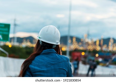Woman Engineer Entrepreneur Construction Industry Worker. Female Engineer Working Refinery Oil Plant Manufacturing. Young Civil Engineering Construction Wear Hard Hat Safety Helmet Construction Site.