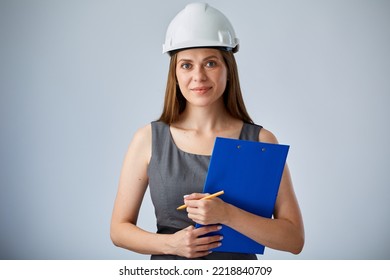 Woman Engineer In White Construction Hardhat Holding Clipboard. Isolated Female Worker Portrait.