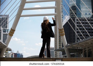 Woman Engineer Working Together On Project With City Background