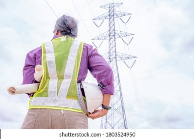 Woman Engineers Construction Worker Checking Layout On Digital Ipad Or Computer. Foreman Working  At Construction Site With Electric Tower Background.