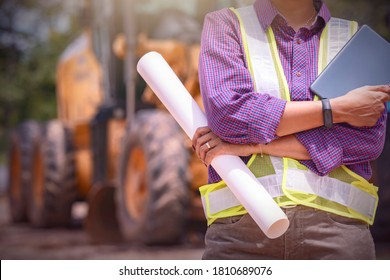 Woman Engineers Construction Worker Checking Layout And Digital Ipad . Foreman Working  At Construction Site.