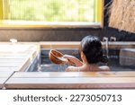 Woman enjoy the onsen in bathtub at resort