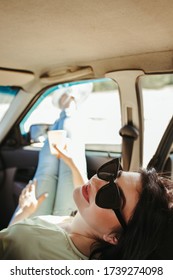 Woman enjoy take-away coffee while traveling by car. Vacation, travel lifestyle and sightseeing