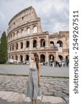 Woman enjoy view of Colosseum (Colosseo) exterior Rome, Italy.