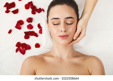 Woman Enjoying Anti Aging Facial Massage. Pretty Girl Getting Professional Skin Care At Wellness Center. Relaxation, Beauty, Spa And Face Treatment Concept, Top View, Copy Space