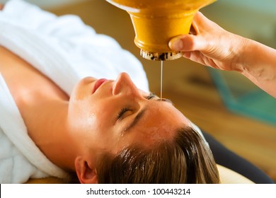 Woman Enjoying A Ayurveda Oil Massage Treatment In A Spa