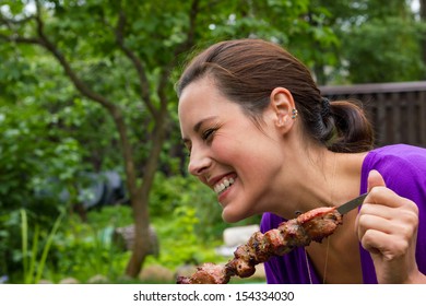 Woman Enjoying Barbecue Outdoors