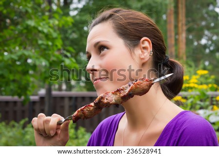 woman enjoying barbecue outdoors