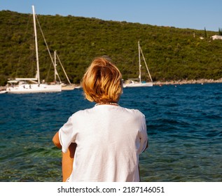 Woman enjoying the beach during the summer vacation. Unrecognizable Caucasian blonde.