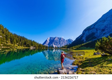 woman enjoying beauty of nature looking at mountain. Adventure travel, Europe. Woman stands on background with Alps.