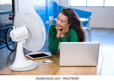 Woman enjoying a breeze in office - Powered by Shutterstock