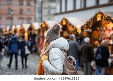 Woman is enjoying the Christmas market in city during the Advent holiday