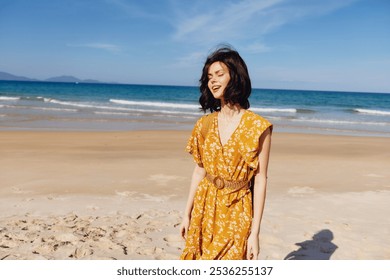 Woman enjoying a coastal sunset in a bright yellow dress with the ocean in the background - Powered by Shutterstock