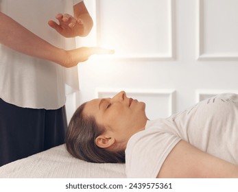 Woman enjoying Energy Healing Reiki Treatment . Chakra Balancing, Aura cleansing, Holistic Health Care concept - Powered by Shutterstock