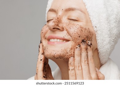 Woman enjoying facial skin care, applying black coffee face scrub, concept of rejuvenation and facial skin care - Powered by Shutterstock