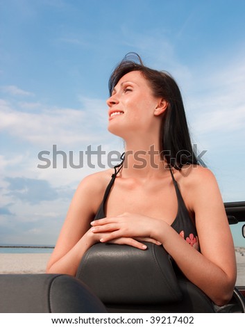 Woman enjoying freetime break weekend with car on scenic beach
