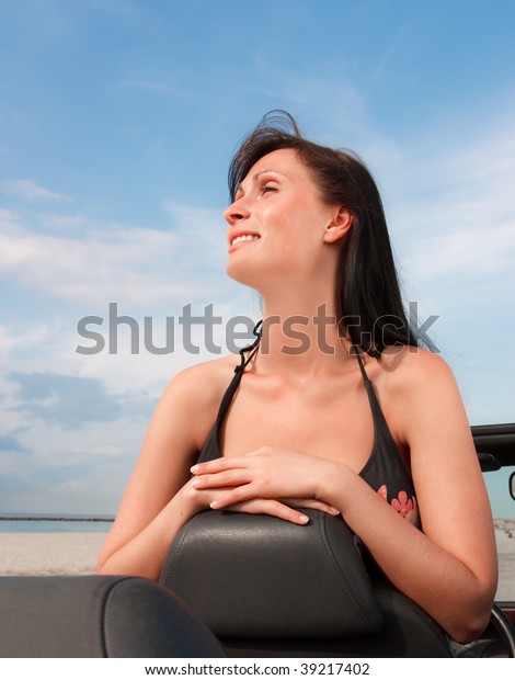 Woman enjoying freetime break weekend with car on\
scenic beach