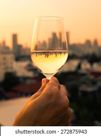 Woman Enjoying A Glass Of Wine Rooftop.