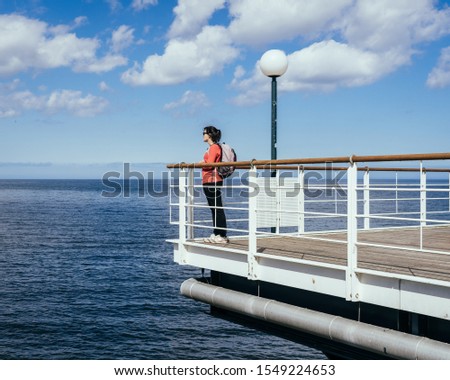 Woman enjoying her time over at the Baltic Sea during autumn and spring seasons.