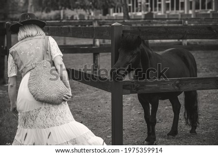 Woman enjoying horse company. Mature Beautiful  With Horse Outdoors, stylish lady at countryside