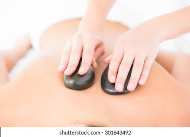 Woman enjoying a hot stone massage at the health spa