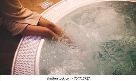 Woman Enjoying Hot Tub In Spa