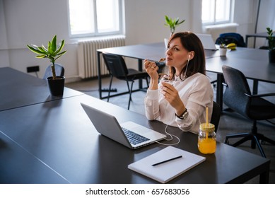 Woman Enjoying Ice Cream In Office