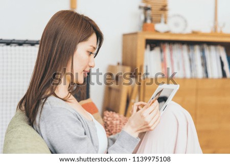 Woman enjoying net shopping while relaxing on the sofa