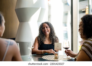 Woman Enjoying A Night Out Downtown At A Hotel Bar With Friends