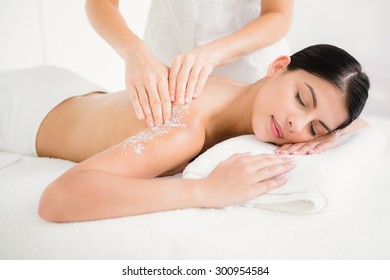 Woman Enjoying A Salt Scrub Massage At The Health Spa