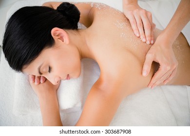 Woman Enjoying A Salt Scrub Massage At The Health Spa