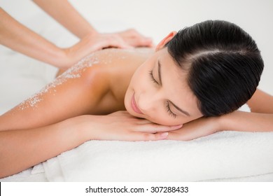 Woman Enjoying A Salt Scrub Massage At The Health Spa