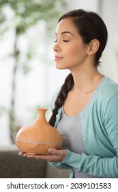 Woman Enjoying The Scent From An Aromatherapy Diffuser