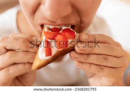 woman enjoying a snack of toast with strawberries and yogurt