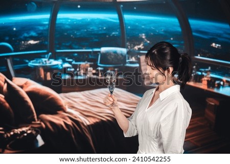 Woman enjoying sparkling wine at a hotel in space