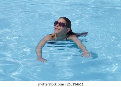 Woman Enjoying A Swim In Swimming Pool