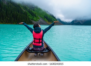 Woman enjoying the view of Lake Louise from Canoe - Powered by Shutterstock