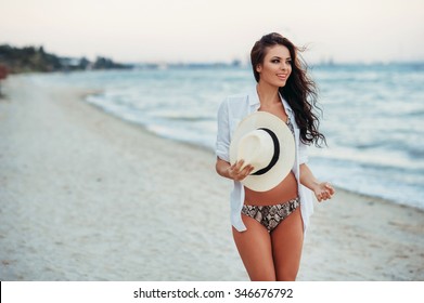 woman enjoying a walk on the beach