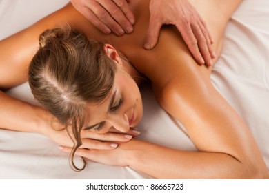 Woman enjoying a wellness back massage in a spa, she is very relaxed (close-up) - Shutterstock ID 86665723